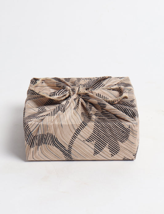 A delicately handcrafted wrap made from recycled sari offcuts, blending sustainable fashion with conscious design. This eco-friendly product showcases the beauty of upcycling and green fashion, making it a perfect accessory for those supporting circular fashion and products made from textile waste.