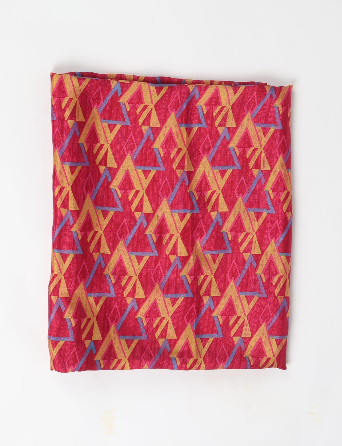 Folded pink pareo with yellow and blue geometric triangle pattern on a white background