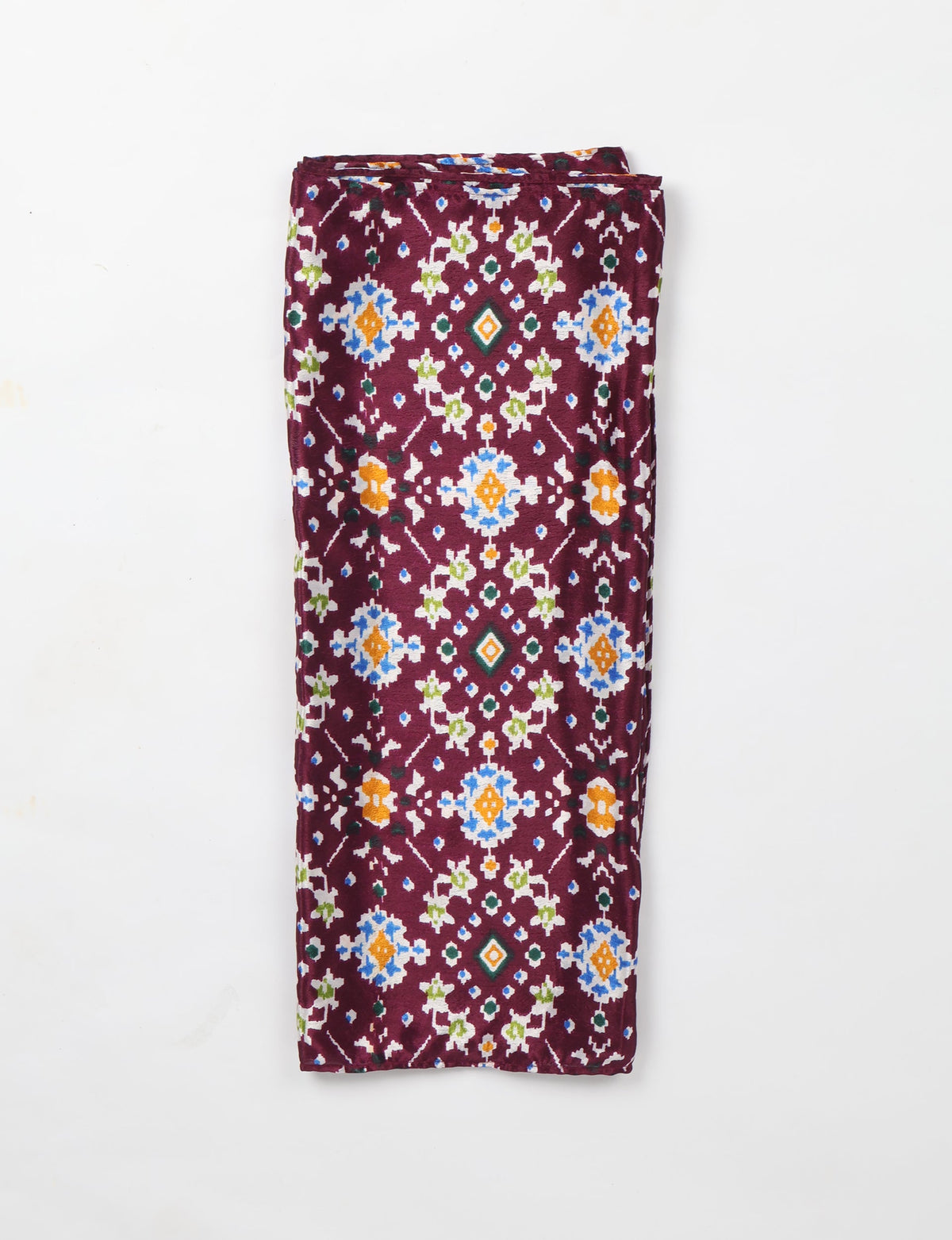 Folded purple stole with multicolor ethnic geometric patterns in blue, orange, green, and white on a white background