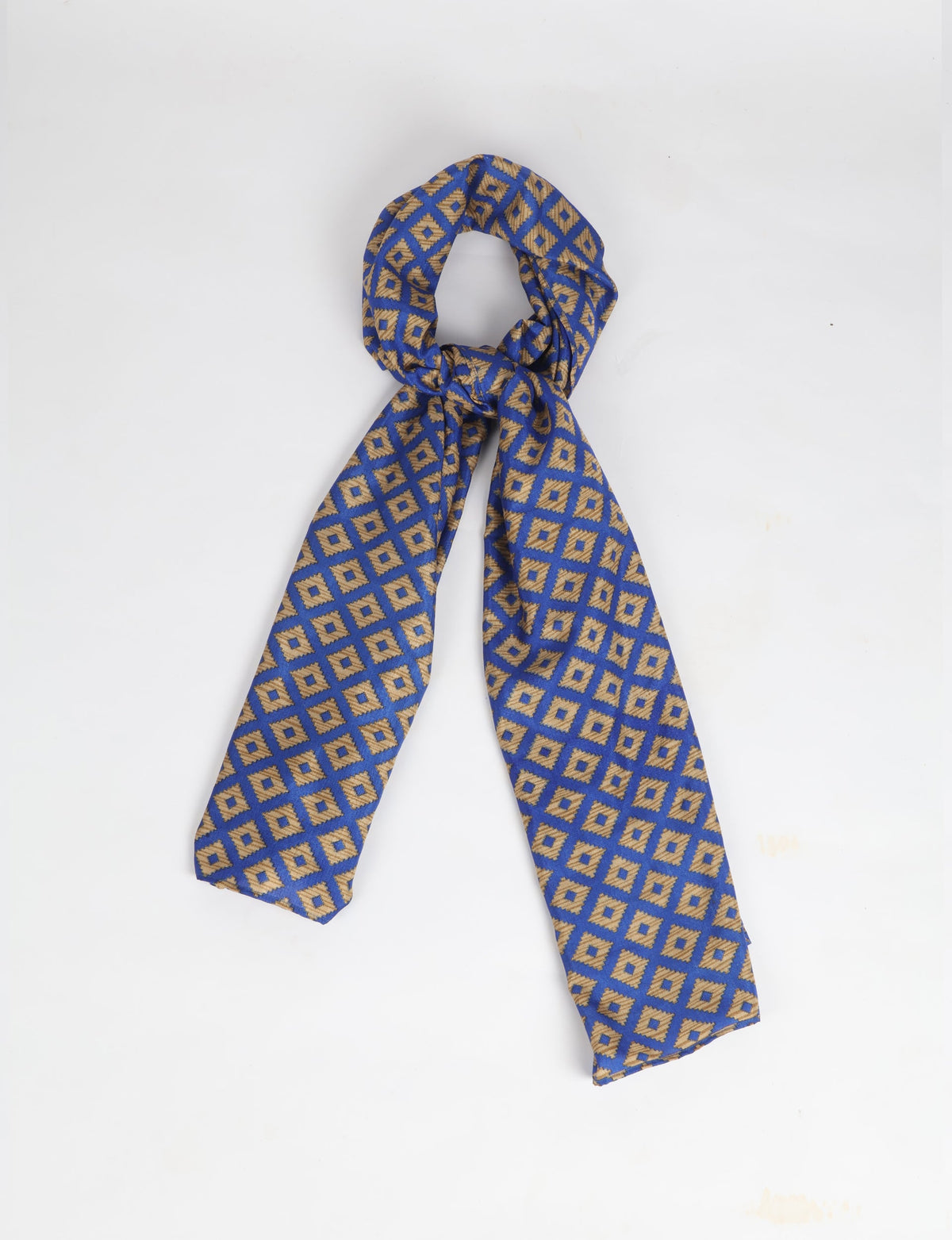 Blue stole with gold geometric diamond pattern, shown knotted against a white background