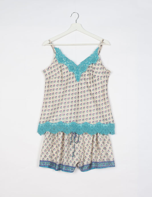 Sleep in eco-friendly luxury with our PJ Set Short. Made for the conscious consumer, these pajamas contribute to zero waste and sustainable practices. The cami top, adorned with delicate eyelash lace and cut on the bias, pairs seamlessly with the comfy shorts featuring an elasticated waist and drawstring tie.