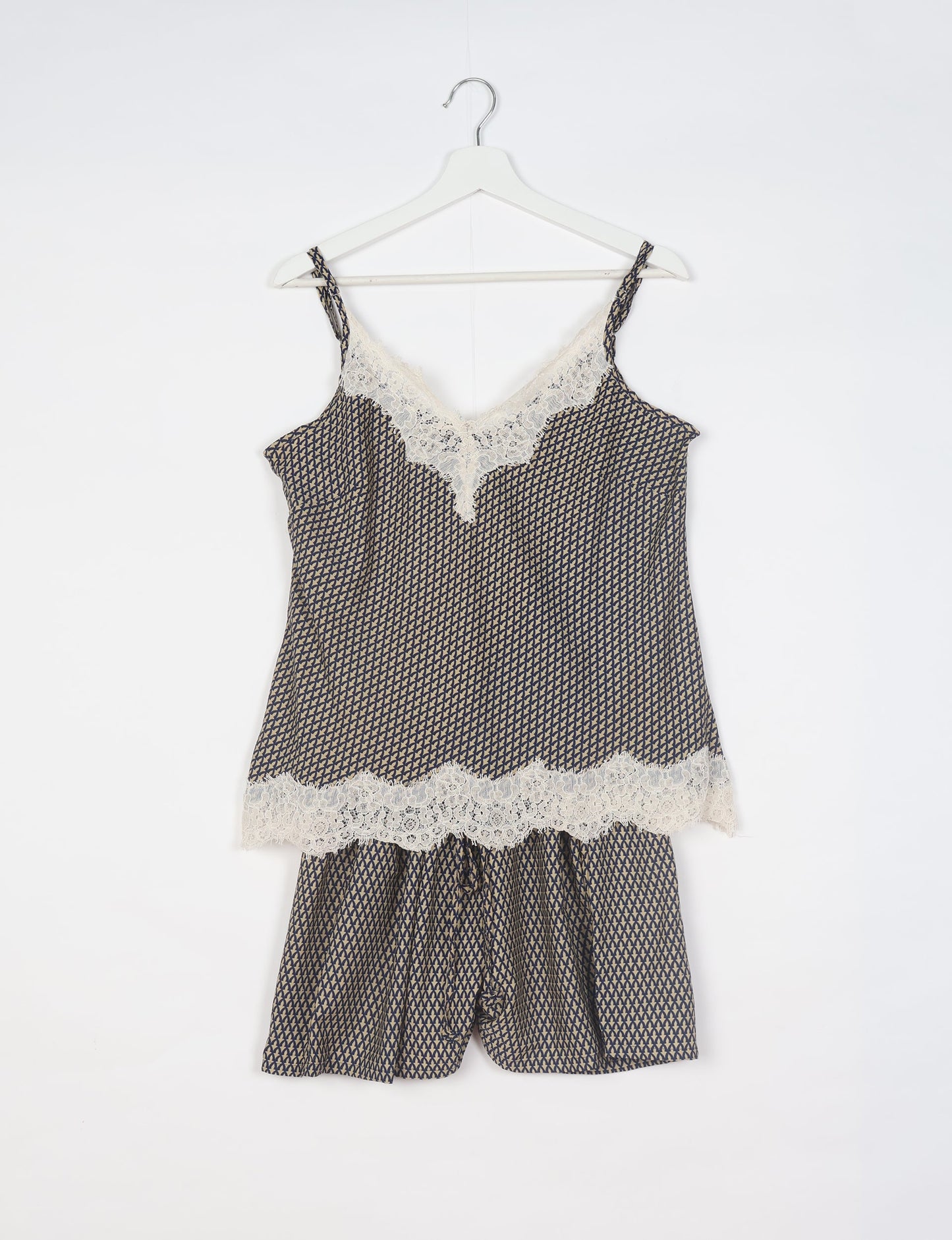 Sleep in eco-friendly luxury with our PJ Set Short. Made for the conscious consumer, these pajamas contribute to zero waste and sustainable practices. The cami top, adorned with delicate eyelash lace and cut on the bias, pairs seamlessly with the comfy shorts featuring an elasticated waist and drawstring tie.