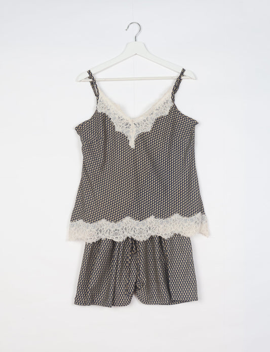 Sleep in eco-friendly luxury with our PJ Set Short. Made for the conscious consumer, these pajamas contribute to zero waste and sustainable practices. The cami top, adorned with delicate eyelash lace and cut on the bias, pairs seamlessly with the comfy shorts featuring an elasticated waist and drawstring tie.