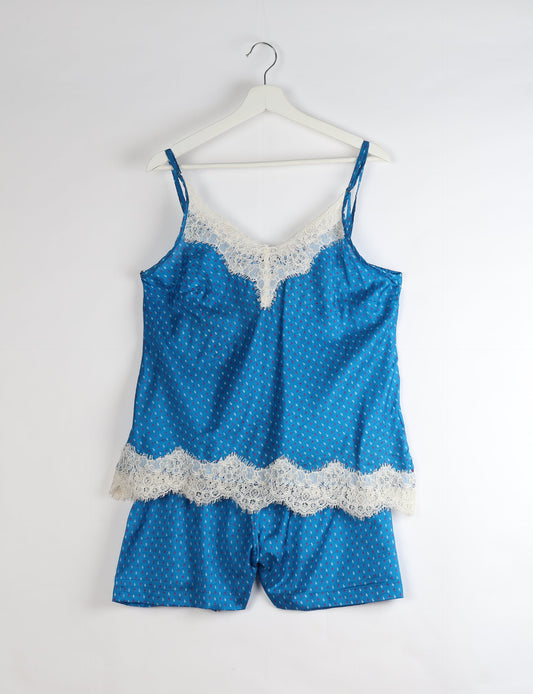 Sleep in eco-friendly luxury with our PJ Set Short. Made for the conscious consumer, these pajamas contribute to zero waste and sustainable practices. The cami top, adorned with delicate eyelash lace and cut on the bias, pairs seamlessly with the comfy shorts featuring an elasticated waist and drawstring tie.