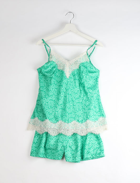 Sleep in eco-friendly luxury with our PJ Set Short. Made for the conscious consumer, these pajamas contribute to zero waste and sustainable practices. The cami top, adorned with delicate eyelash lace and cut on the bias, pairs seamlessly with the comfy shorts featuring an elasticated waist and drawstring tie.