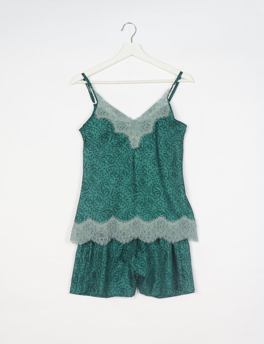 Sleep in eco-friendly luxury with our PJ Set Short. Made for the conscious consumer, these pajamas contribute to zero waste and sustainable practices. The cami top, adorned with delicate eyelash lace and cut on the bias, pairs seamlessly with the comfy shorts featuring an elasticated waist and drawstring tie.