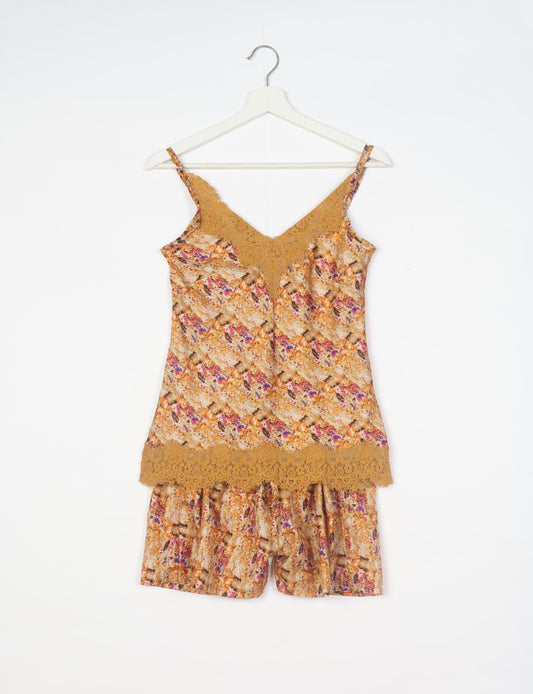 Sleep in eco-friendly luxury with our PJ Set Short. Made for the conscious consumer, these pajamas contribute to zero waste and sustainable practices. The cami top, adorned with delicate eyelash lace and cut on the bias, pairs seamlessly with the comfy shorts featuring an elasticated waist and drawstring tie.