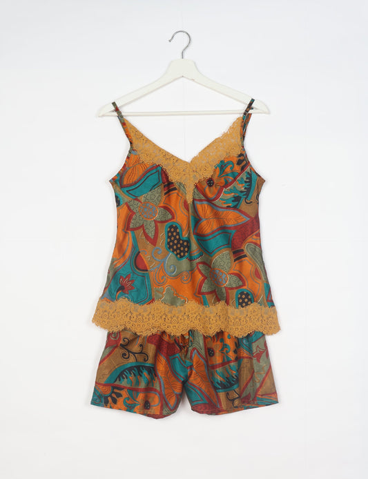 Sleep in eco-friendly luxury with our PJ Set Short. Made for the conscious consumer, these pajamas contribute to zero waste and sustainable practices. The cami top, adorned with delicate eyelash lace and cut on the bias, pairs seamlessly with the comfy shorts featuring an elasticated waist and drawstring tie.