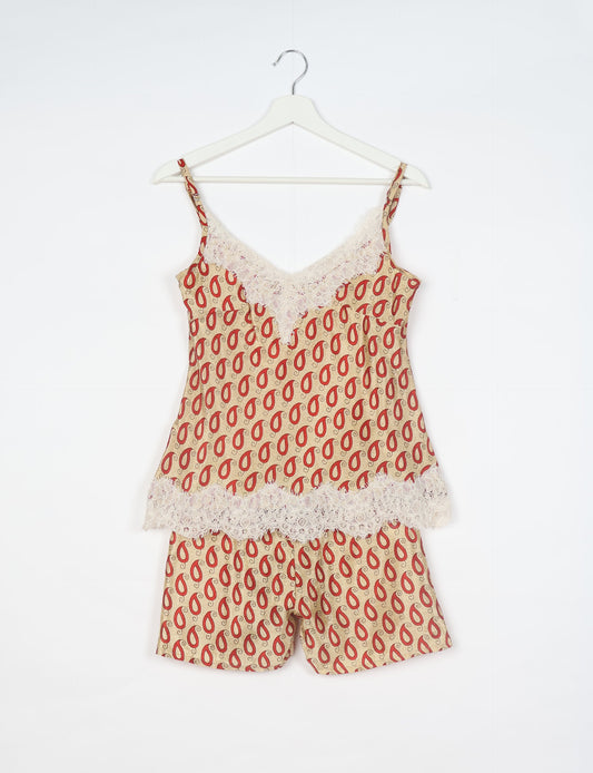 Sleep in eco-friendly luxury with our PJ Set Short. Made for the conscious consumer, these pajamas contribute to zero waste and sustainable practices. The cami top, adorned with delicate eyelash lace and cut on the bias, pairs seamlessly with the comfy shorts featuring an elasticated waist and drawstring tie.