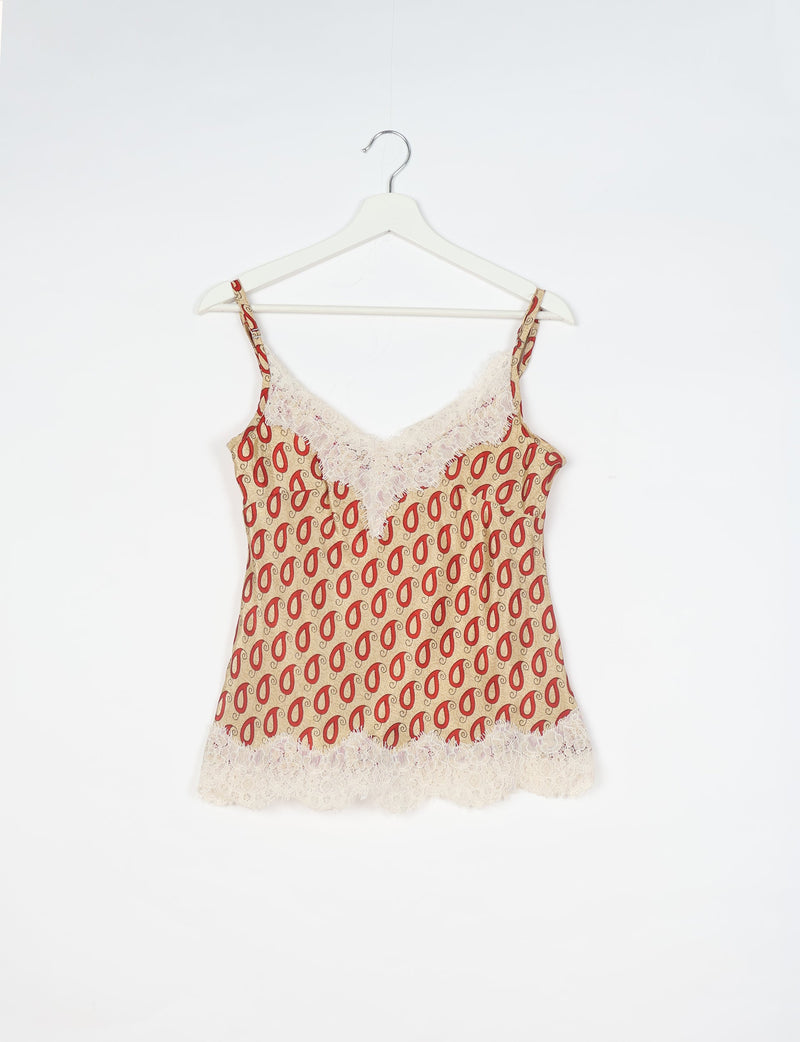 Beige paisley print camisole with red teardrop shapes, lace trim on neckline and hem, hanging on white hanger