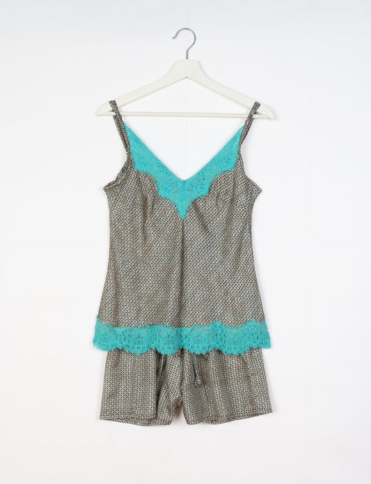 Sleep in eco-friendly luxury with our PJ Set Short. Made for the conscious consumer, these pajamas contribute to zero waste and sustainable practices. The cami top, adorned with delicate eyelash lace and cut on the bias, pairs seamlessly with the comfy shorts featuring an elasticated waist and drawstring tie.