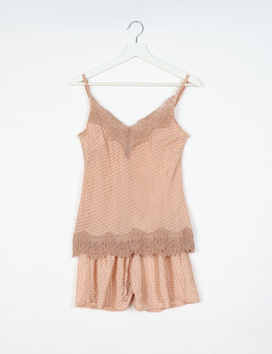 Sleep in eco-friendly luxury with our PJ Set Short. Made for the conscious consumer, these pajamas contribute to zero waste and sustainable practices. The cami top, adorned with delicate eyelash lace and cut on the bias, pairs seamlessly with the comfy shorts featuring an elasticated waist and drawstring tie.