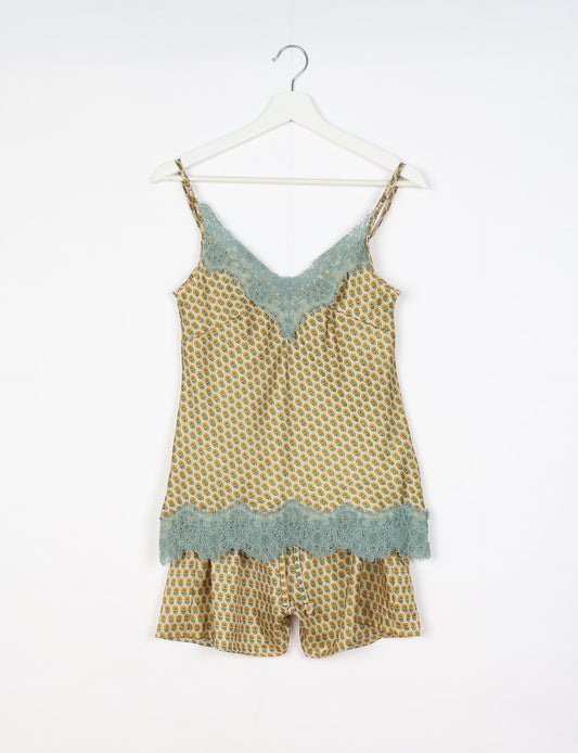 Sleep in eco-friendly luxury with our PJ Set Short. Made for the conscious consumer, these pajamas contribute to zero waste and sustainable practices. The cami top, adorned with delicate eyelash lace and cut on the bias, pairs seamlessly with the comfy shorts featuring an elasticated waist and drawstring tie.