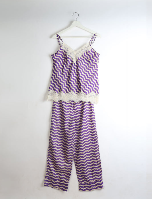 Purple and white abstract patterned pajama set with lace trim on camisole neckline and hem, shown hanging on white hanger
