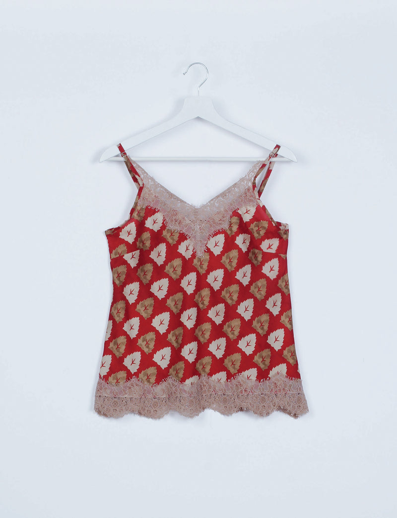 Red floral sleeveless pajama top with beige lace trim on neckline and hem, hanging on white hanger against white background