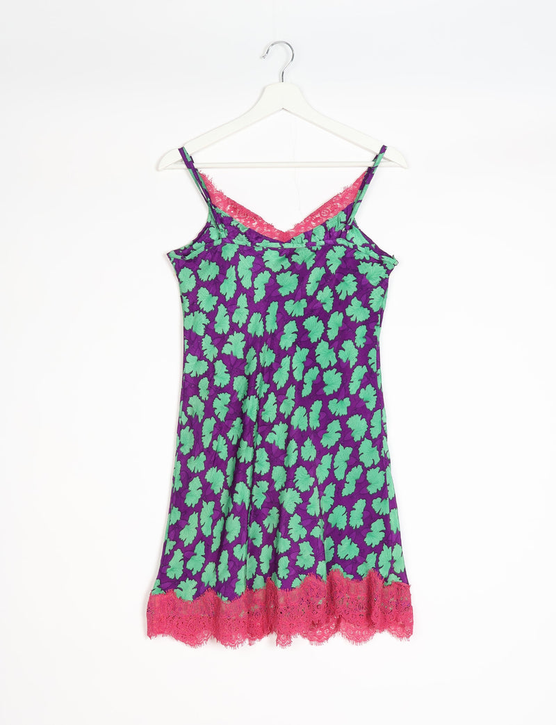 Purple night dress with green leaf pattern, pink lace trim at neckline and hem, spaghetti straps, hanging on white hanger