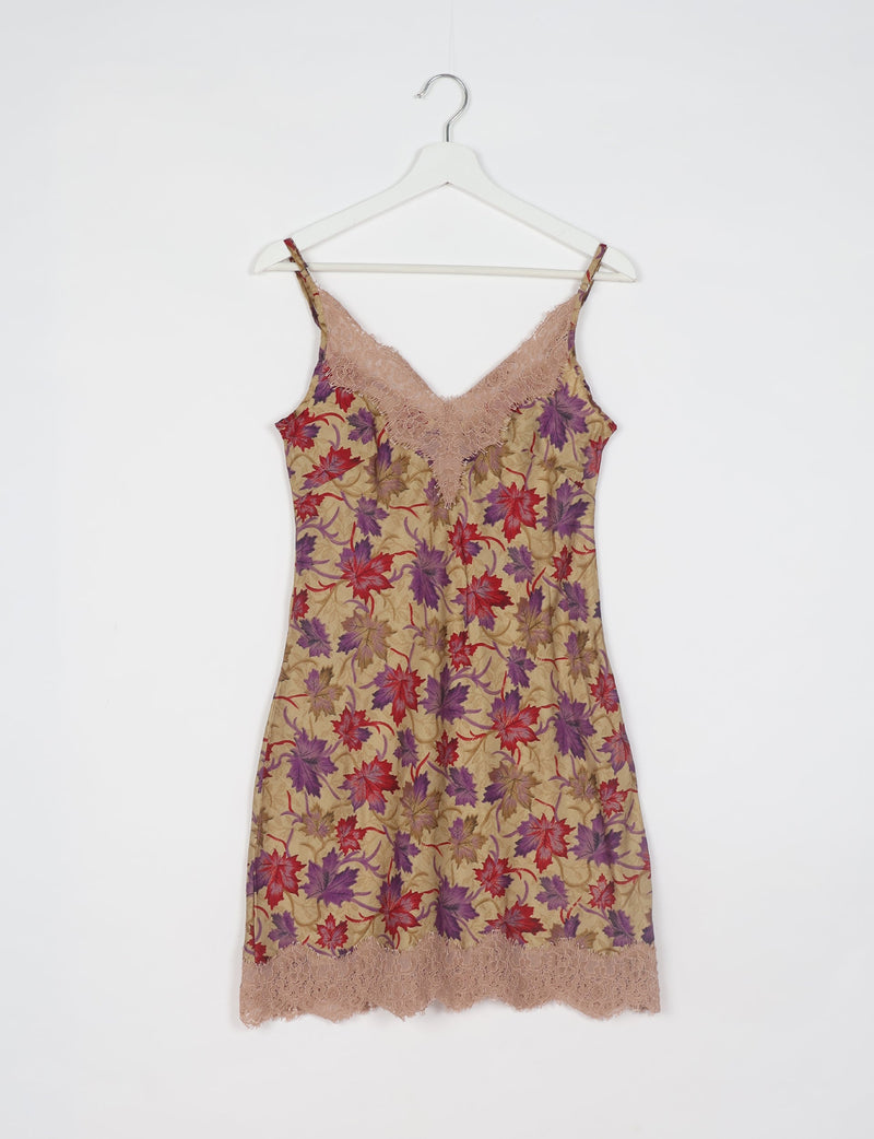 Beige night dress with red and purple leaf pattern, lace trim at neckline and hem, hanging on white hanger