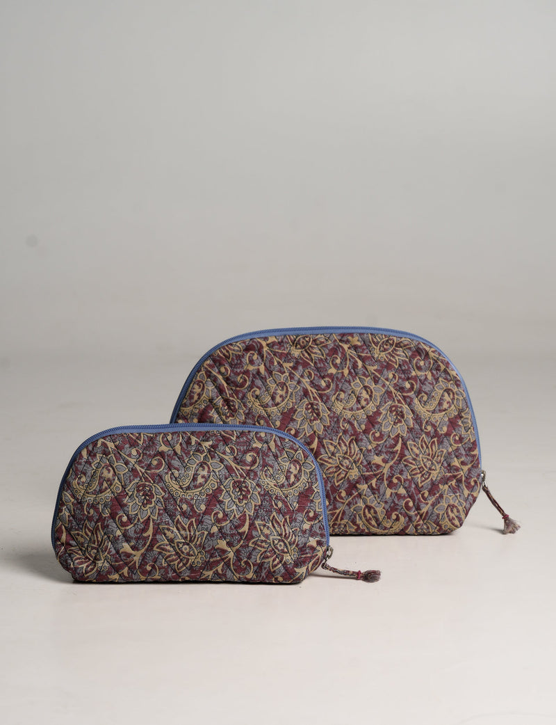 Set of two purple floral patterned vanity pouches with blue zipper trim, shown front view on a plain background