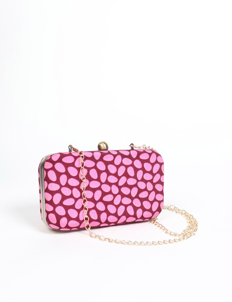 Rectangular pink clutch handbag with darker pink oval pattern, gold-tone frame, clasp, and chain strap, front view
