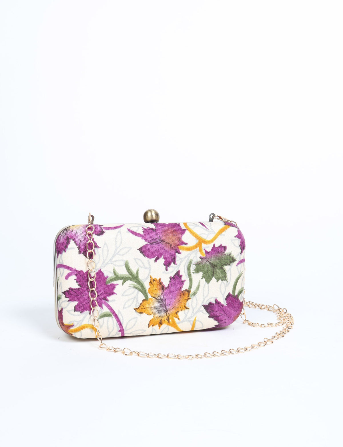 Rectangular clutch handbag with white fabric featuring purple, orange, and green leaf print, gold chain strap, and round