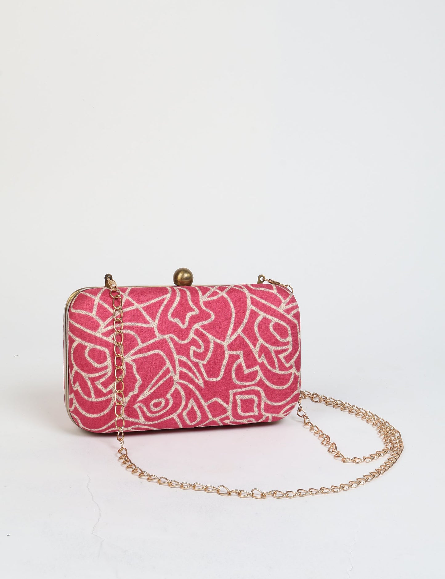 Pink clutch handbag with abstract white pattern and gold chain strap, front view on white background