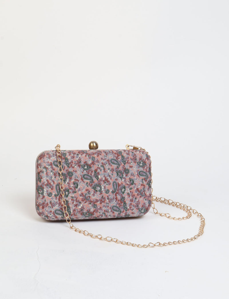 Rectangular pink tropical print clutch handbag with gold-tone clasp and chain strap, front view on white background
