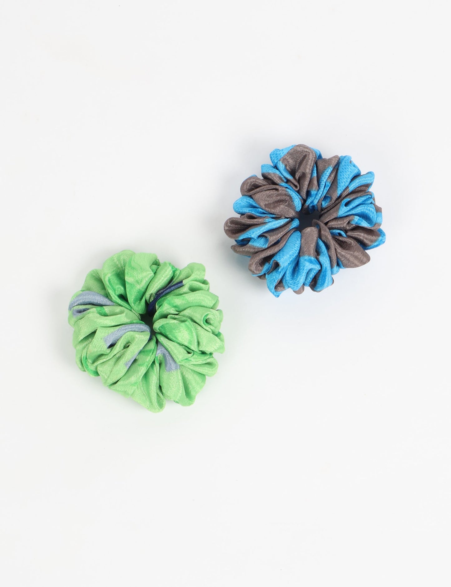 Upgrade your hairstyle with our Scrunchy Set of 2 – elastic hair ties wrapped in colorful Indian sari fabric. A top pick in ethical and green fashion, these eco-friendly prints add flair to your wrist and hair, making a sustainable style statement that catches attention and sparks change.