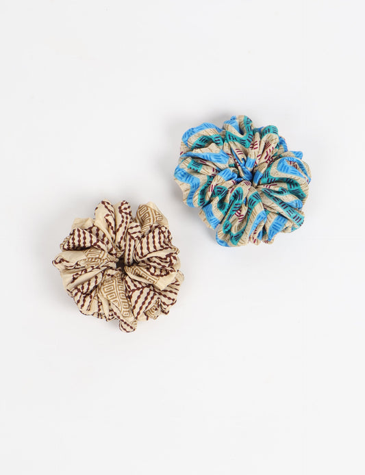 Upgrade your hairstyle with our Scrunchy Set of 2 – elastic hair ties wrapped in colorful Indian sari fabric. A top pick in ethical and green fashion, these eco-friendly prints add flair to your wrist and hair, making a sustainable style statement that catches attention and sparks change.