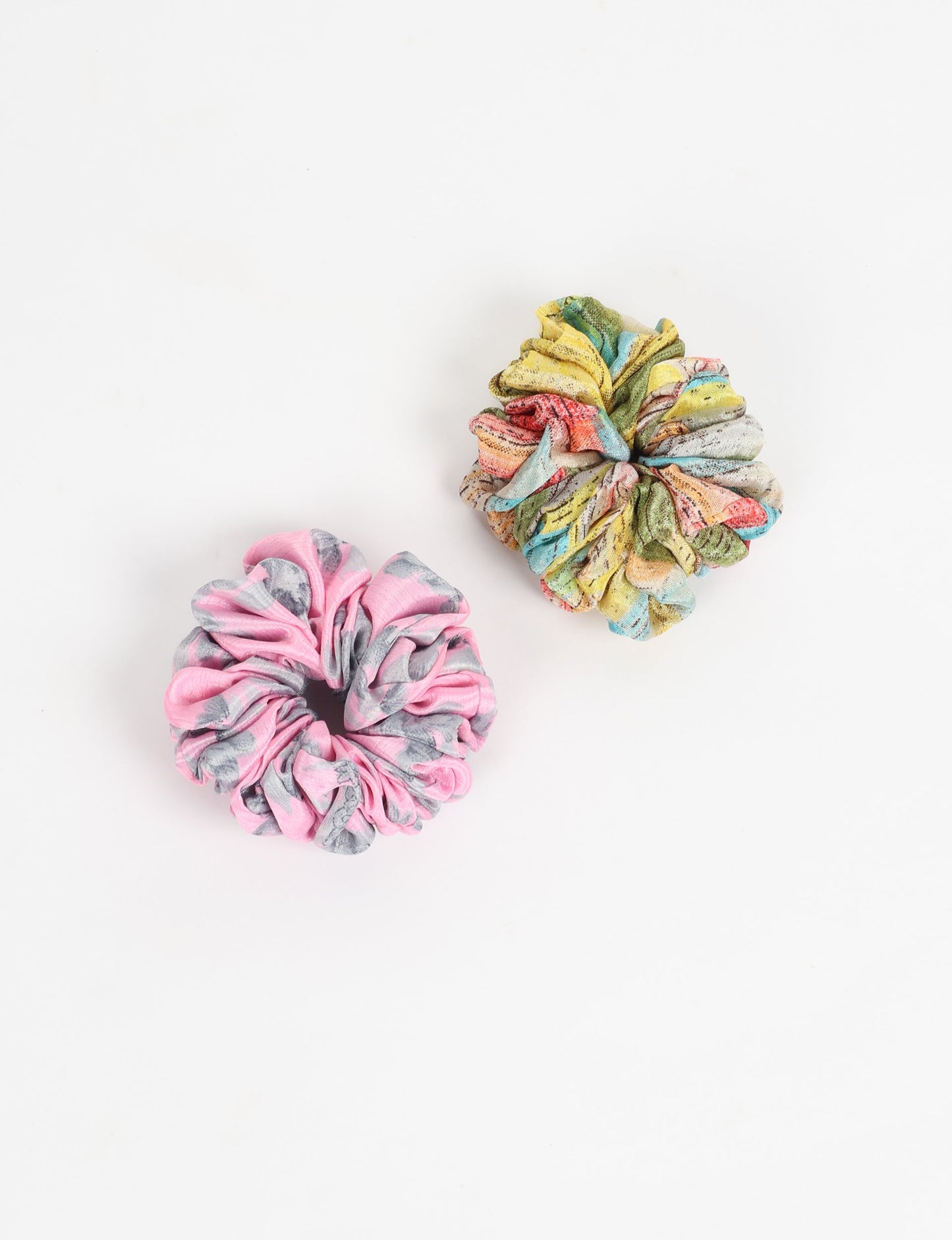 Upgrade your hairstyle with our Scrunchy Set of 2 – elastic hair ties wrapped in colorful Indian sari fabric. A top pick in ethical and green fashion, these eco-friendly prints add flair to your wrist and hair, making a sustainable style statement that catches attention and sparks change.