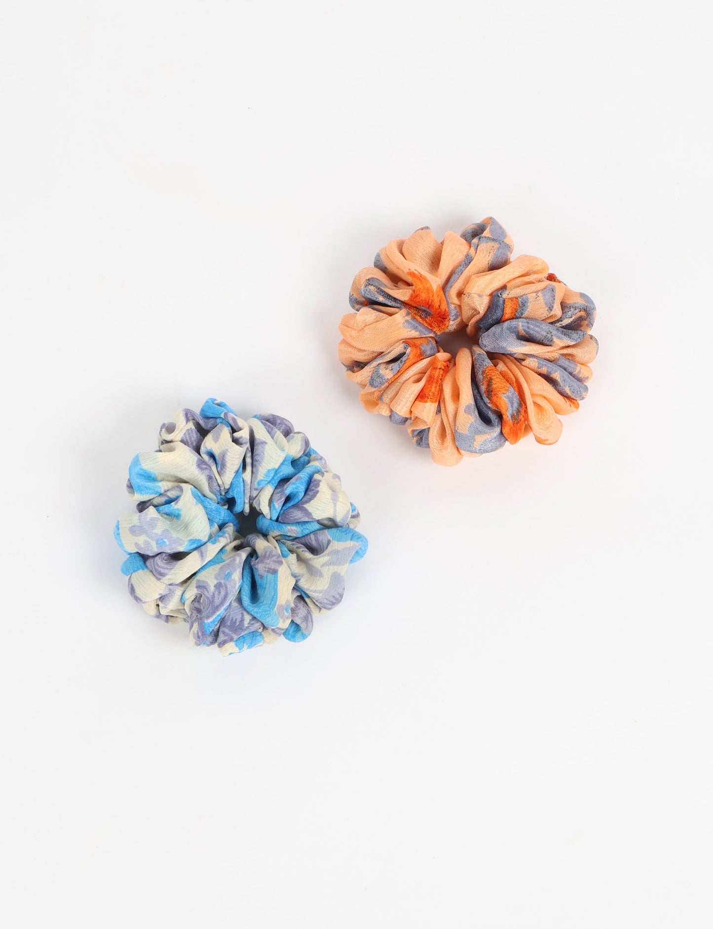 Upgrade your hairstyle with our Scrunchy Set of 2 – elastic hair ties wrapped in colorful Indian sari fabric. A top pick in ethical and green fashion, these eco-friendly prints add flair to your wrist and hair, making a sustainable style statement that catches attention and sparks change.