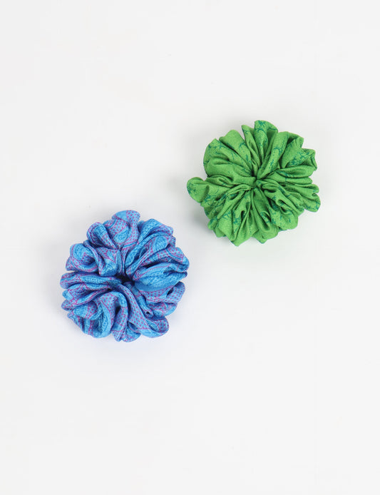Upgrade your hairstyle with our Scrunchy Set of 2 – elastic hair ties wrapped in colorful Indian sari fabric. A top pick in ethical and green fashion, these eco-friendly prints add flair to your wrist and hair, making a sustainable style statement that catches attention and sparks change.