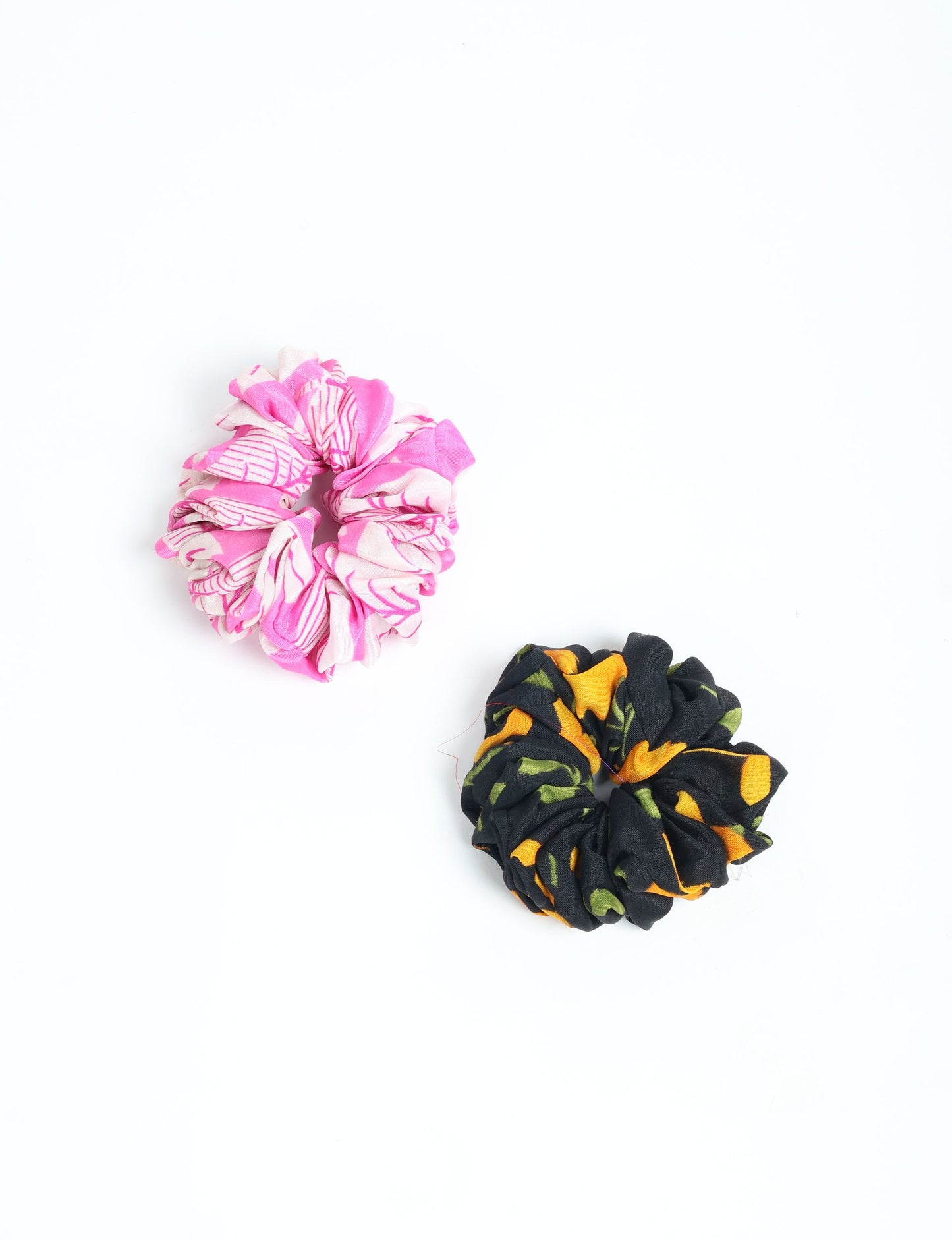 Upgrade your hairstyle with our Scrunchy Set of 2 – elastic hair ties wrapped in colorful Indian sari fabric. A top pick in ethical and green fashion, these eco-friendly prints add flair to your wrist and hair, making a sustainable style statement that catches attention and sparks change.