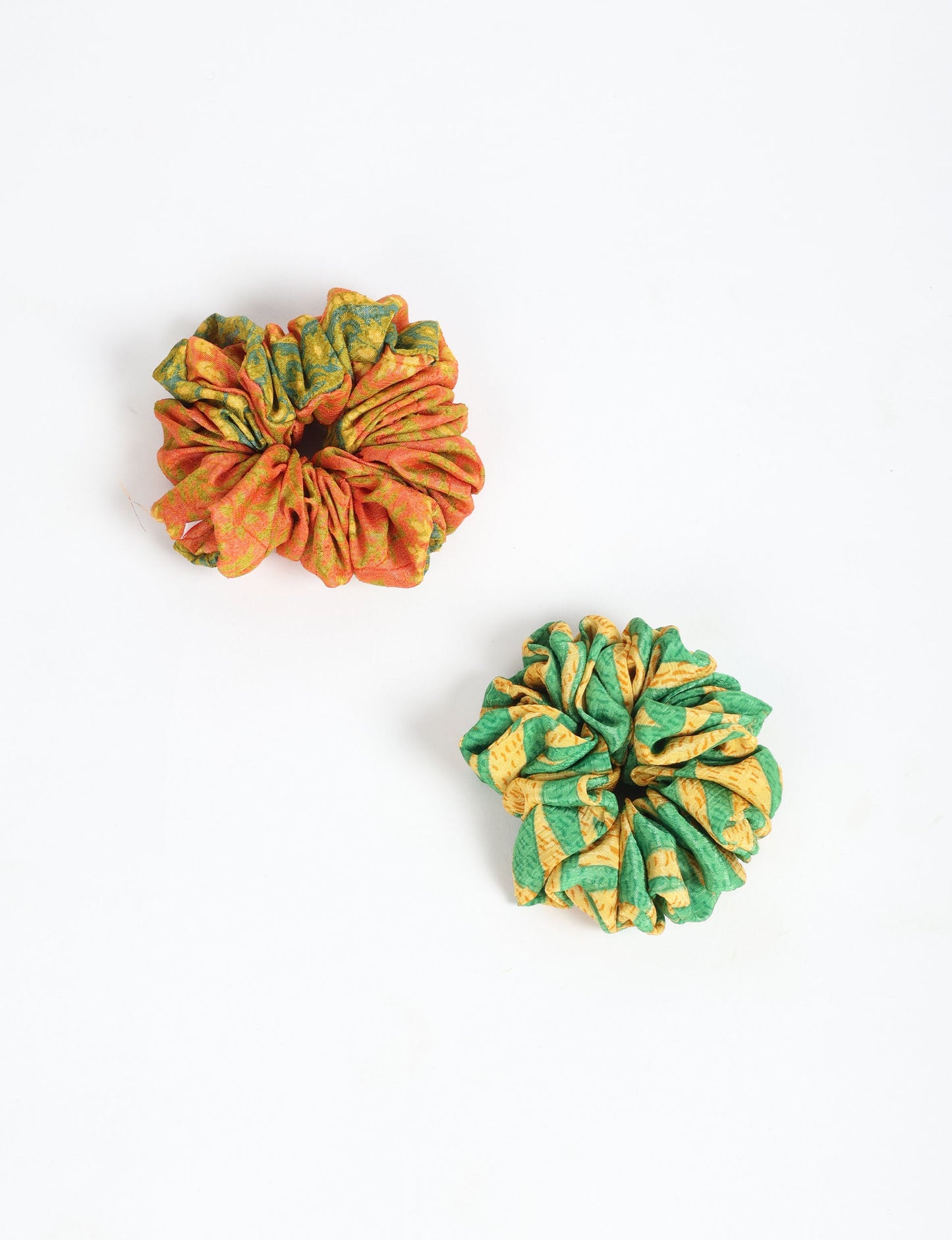 Upgrade your hairstyle with our Scrunchy Set of 2 – elastic hair ties wrapped in colorful Indian sari fabric. A top pick in ethical and green fashion, these eco-friendly prints add flair to your wrist and hair, making a sustainable style statement that catches attention and sparks change.
