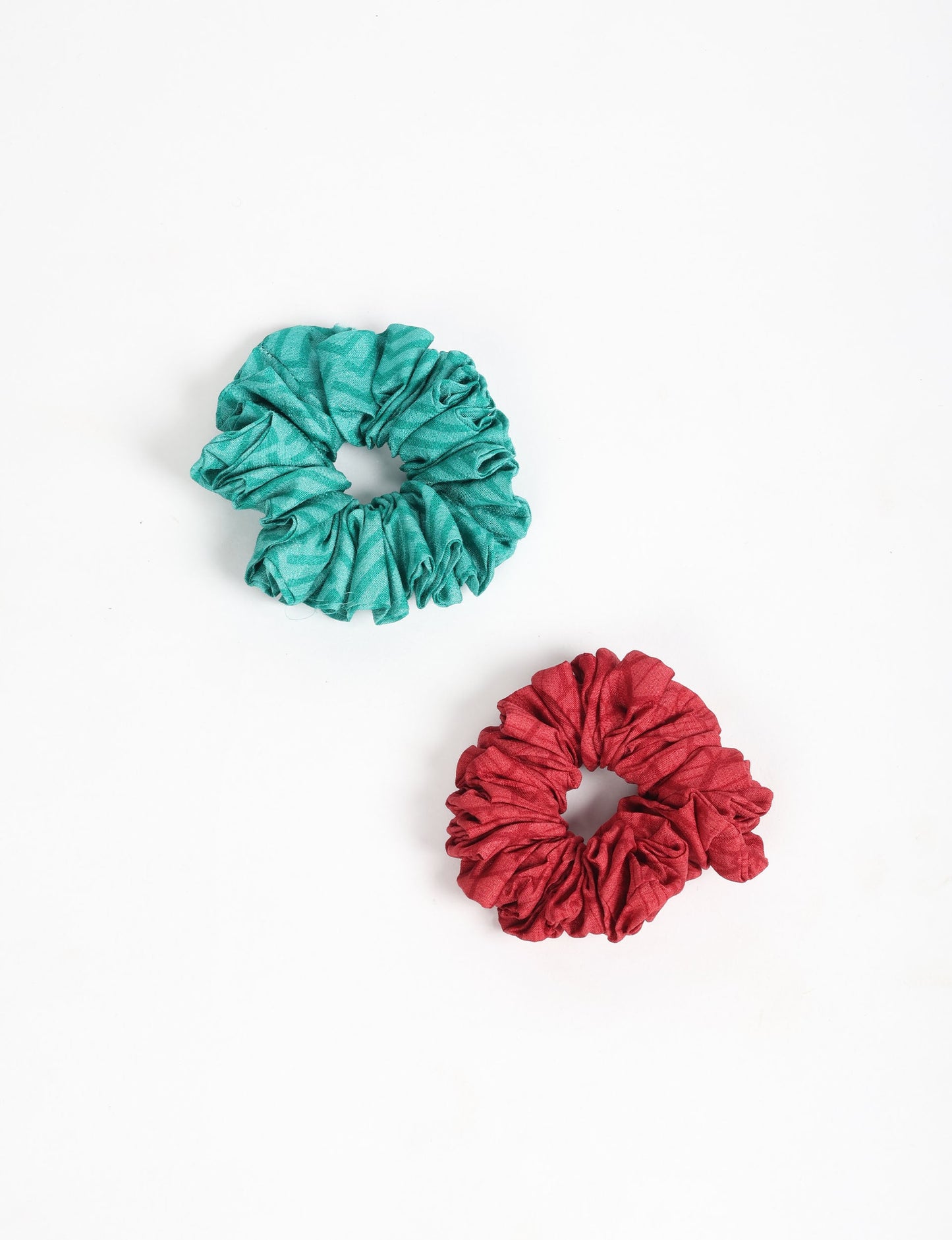 Upgrade your hairstyle with our Scrunchy Set of 2 – elastic hair ties wrapped in colorful Indian sari fabric. A top pick in ethical and green fashion, these eco-friendly prints add flair to your wrist and hair, making a sustainable style statement that catches attention and sparks change.
