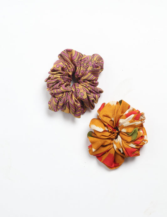 Upgrade your hairstyle with our Scrunchy Set of 2 – elastic hair ties wrapped in colorful Indian sari fabric. A top pick in ethical and green fashion, these eco-friendly prints add flair to your wrist and hair, making a sustainable style statement that catches attention and sparks change.