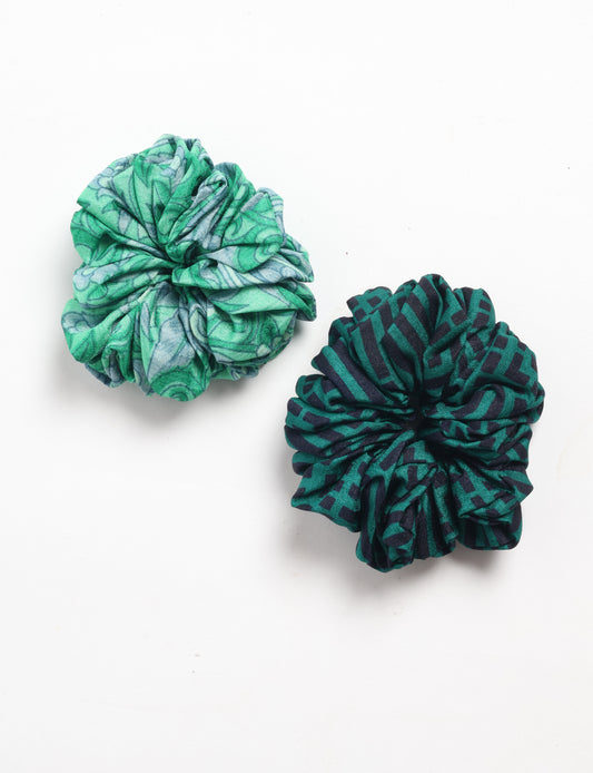Set of two fabric scrunchies, one with green and gray abstract pattern, the other with dark green and black geometric