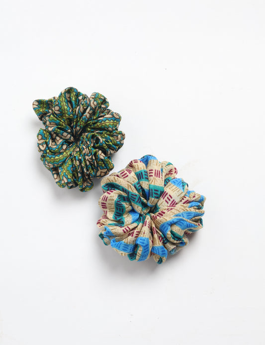 Upgrade your hairstyle with our Scrunchy Set of 2 – elastic hair ties wrapped in colorful Indian sari fabric. A top pick in ethical and green fashion, these eco-friendly prints add flair to your wrist and hair, making a sustainable style statement that catches attention and sparks change.