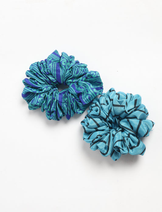 Upgrade your hairstyle with our Scrunchy Set of 2 – elastic hair ties wrapped in colorful Indian sari fabric. A top pick in ethical and green fashion, these eco-friendly prints add flair to your wrist and hair, making a sustainable style statement that catches attention and sparks change.