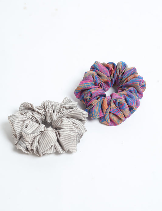 Upgrade your hairstyle with our Scrunchy Set of 2 – elastic hair ties wrapped in colorful Indian sari fabric. A top pick in ethical and green fashion, these eco-friendly prints add flair to your wrist and hair, making a sustainable style statement that catches attention and sparks change.