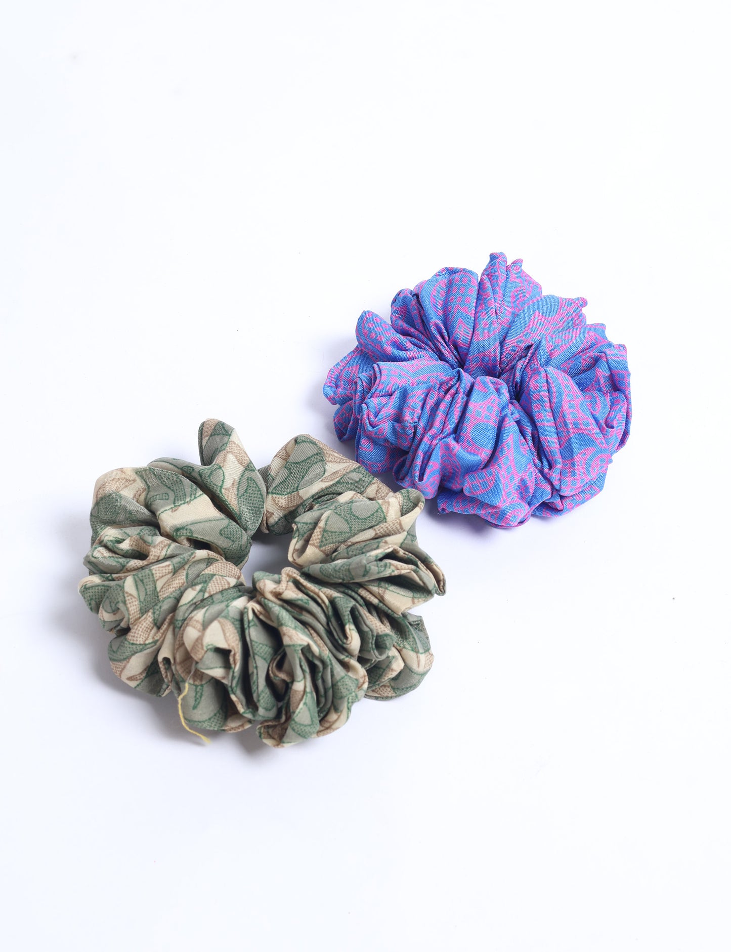 Upgrade your hairstyle with our Scrunchy Set of 2 – elastic hair ties wrapped in colorful Indian sari fabric. A top pick in ethical and green fashion, these eco-friendly prints add flair to your wrist and hair, making a sustainable style statement that catches attention and sparks change.