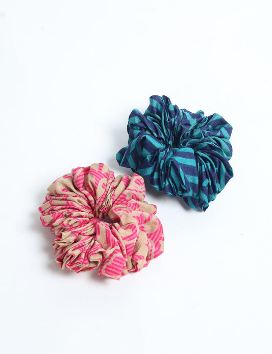 Upgrade your hairstyle with our Scrunchy Set of 2 – elastic hair ties wrapped in colorful Indian sari fabric. A top pick in ethical and green fashion, these eco-friendly prints add flair to your wrist and hair, making a sustainable style statement that catches attention and sparks change.