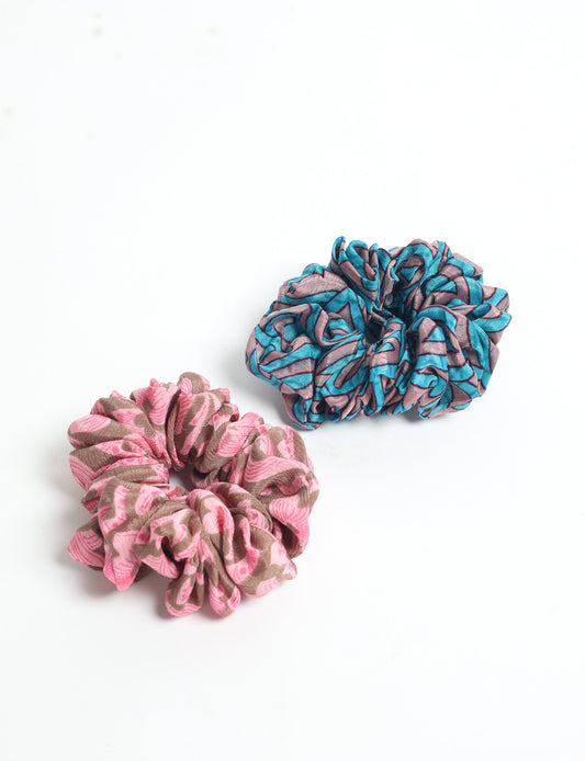 Upgrade your hairstyle with our Scrunchy Set of 2 – elastic hair ties wrapped in colorful Indian sari fabric. A top pick in ethical and green fashion, these eco-friendly prints add flair to your wrist and hair, making a sustainable style statement that catches attention and sparks change.