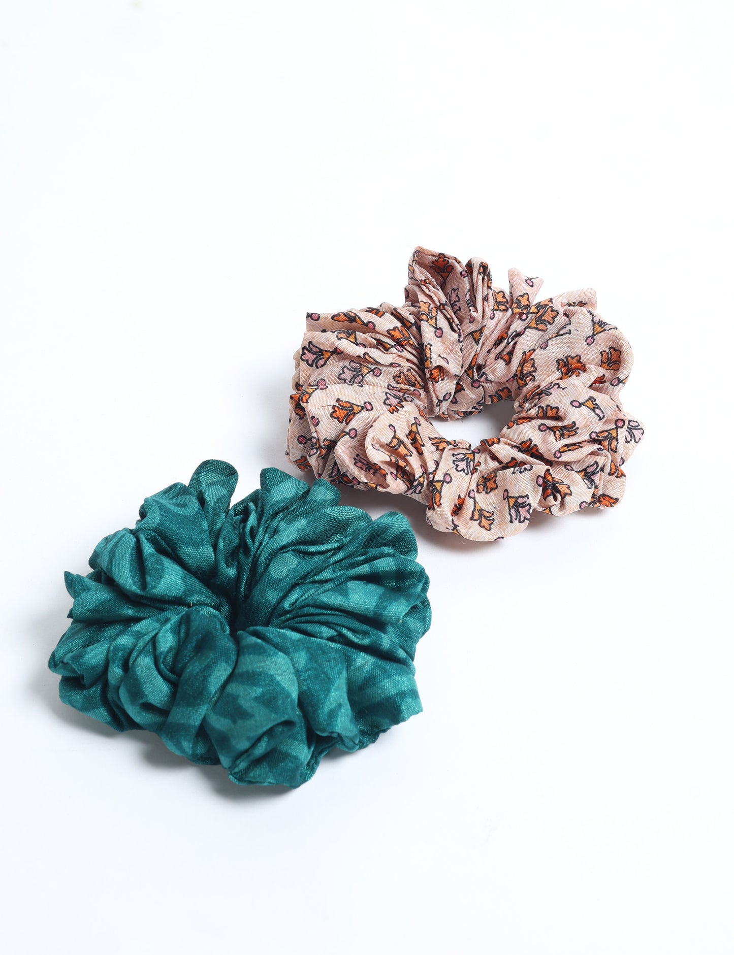 Upgrade your hairstyle with our Scrunchy Set of 2 – elastic hair ties wrapped in colorful Indian sari fabric. A top pick in ethical and green fashion, these eco-friendly prints add flair to your wrist and hair, making a sustainable style statement that catches attention and sparks change.