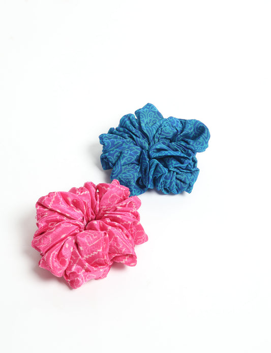 Upgrade your hairstyle with our Scrunchy Set of 2 – elastic hair ties wrapped in colorful Indian sari fabric. A top pick in ethical and green fashion, these eco-friendly prints add flair to your wrist and hair, making a sustainable style statement that catches attention and sparks change.