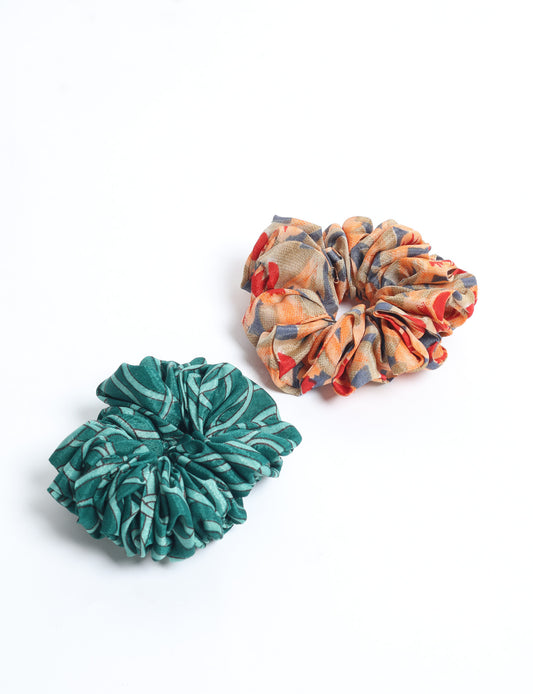 Upgrade your hairstyle with our Scrunchy Set of 2 – elastic hair ties wrapped in colorful Indian sari fabric. A top pick in ethical and green fashion, these eco-friendly prints add flair to your wrist and hair, making a sustainable style statement that catches attention and sparks change.