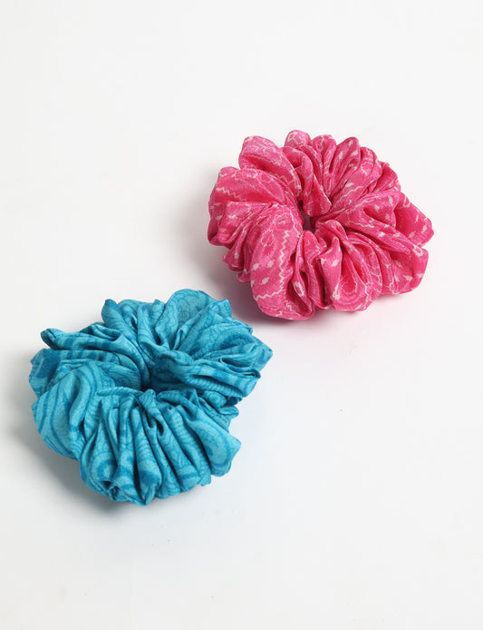Upgrade your hairstyle with our Scrunchy Set of 2 – elastic hair ties wrapped in colorful Indian sari fabric. A top pick in ethical and green fashion, these eco-friendly prints add flair to your wrist and hair, making a sustainable style statement that catches attention and sparks change.