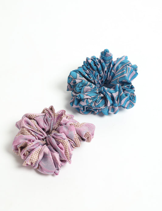 Upgrade your hairstyle with our Scrunchy Set of 2 – elastic hair ties wrapped in colorful Indian sari fabric. A top pick in ethical and green fashion, these eco-friendly prints add flair to your wrist and hair, making a sustainable style statement that catches attention and sparks change.