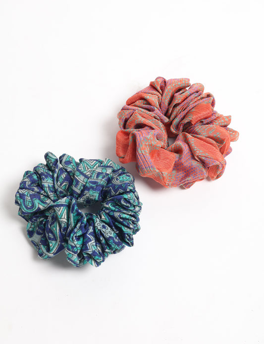 Upgrade your hairstyle with our Scrunchy Set of 2 – elastic hair ties wrapped in colorful Indian sari fabric. A top pick in ethical and green fashion, these eco-friendly prints add flair to your wrist and hair, making a sustainable style statement that catches attention and sparks change.