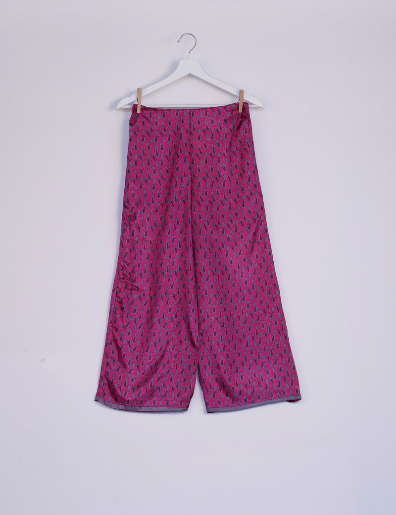 Pink tunic set bottom with micro abstract pattern in dark pink and gray, hanging on white hanger against plain background