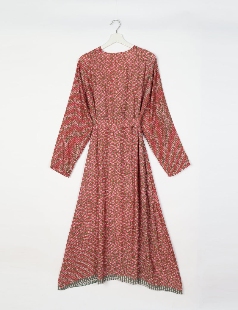 Pink tropical patterned long-sleeve beach robe with belt and gray polka dot trim hanging on white hanger, back view